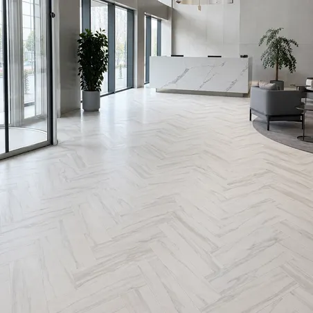 Light herringbone flooring in a reception setting, used as a layout reference